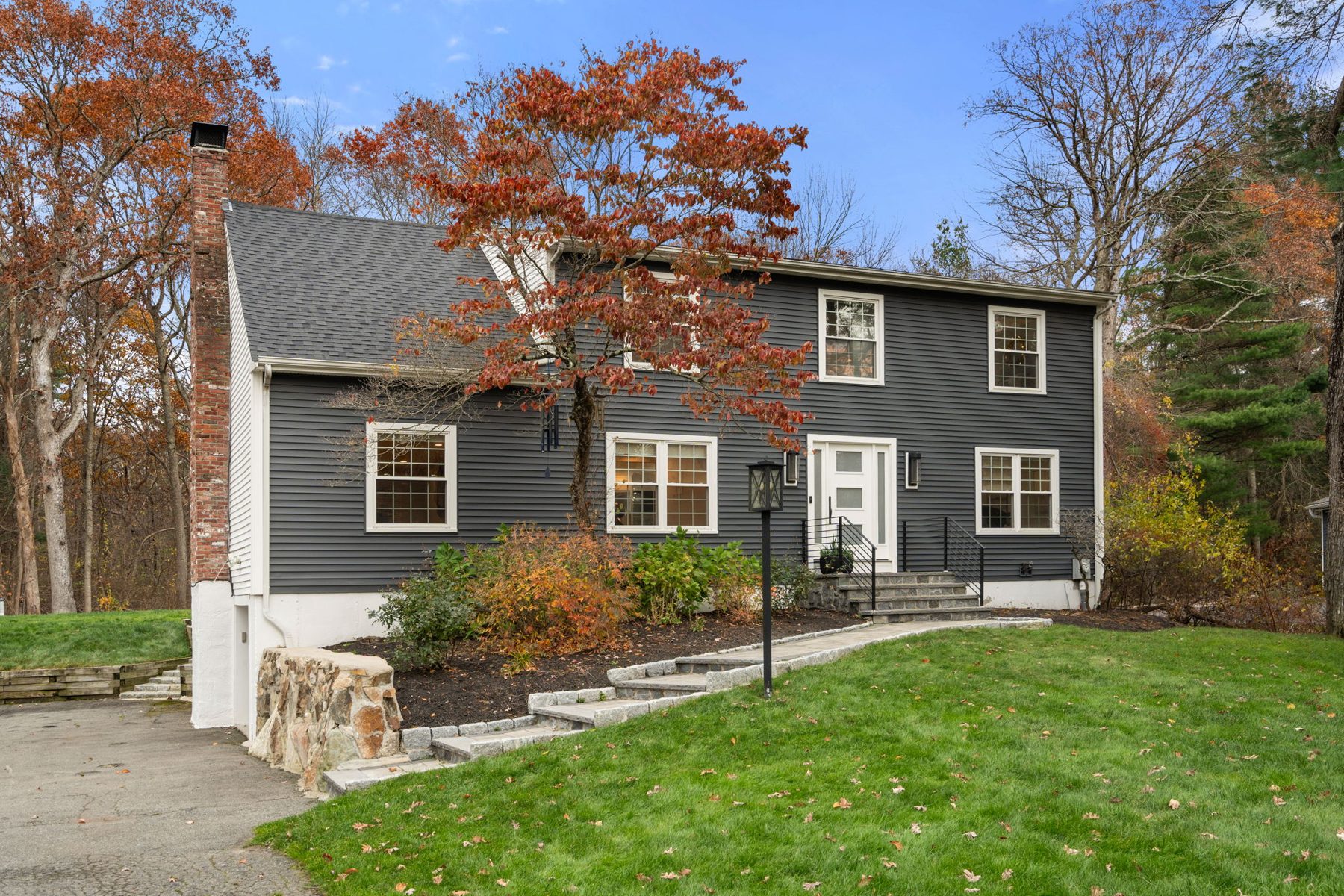 Condor exterior — charcoal siding, new stone steps, November — after