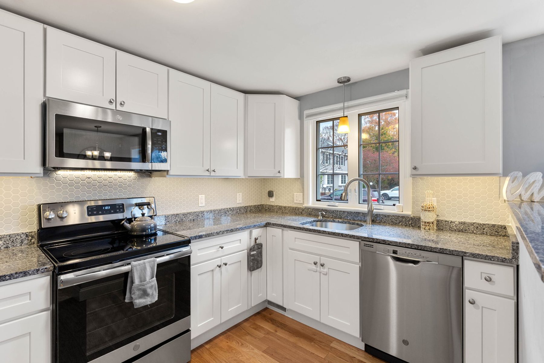 Foundry kitchen — white shaker, granite, hex tile — after
