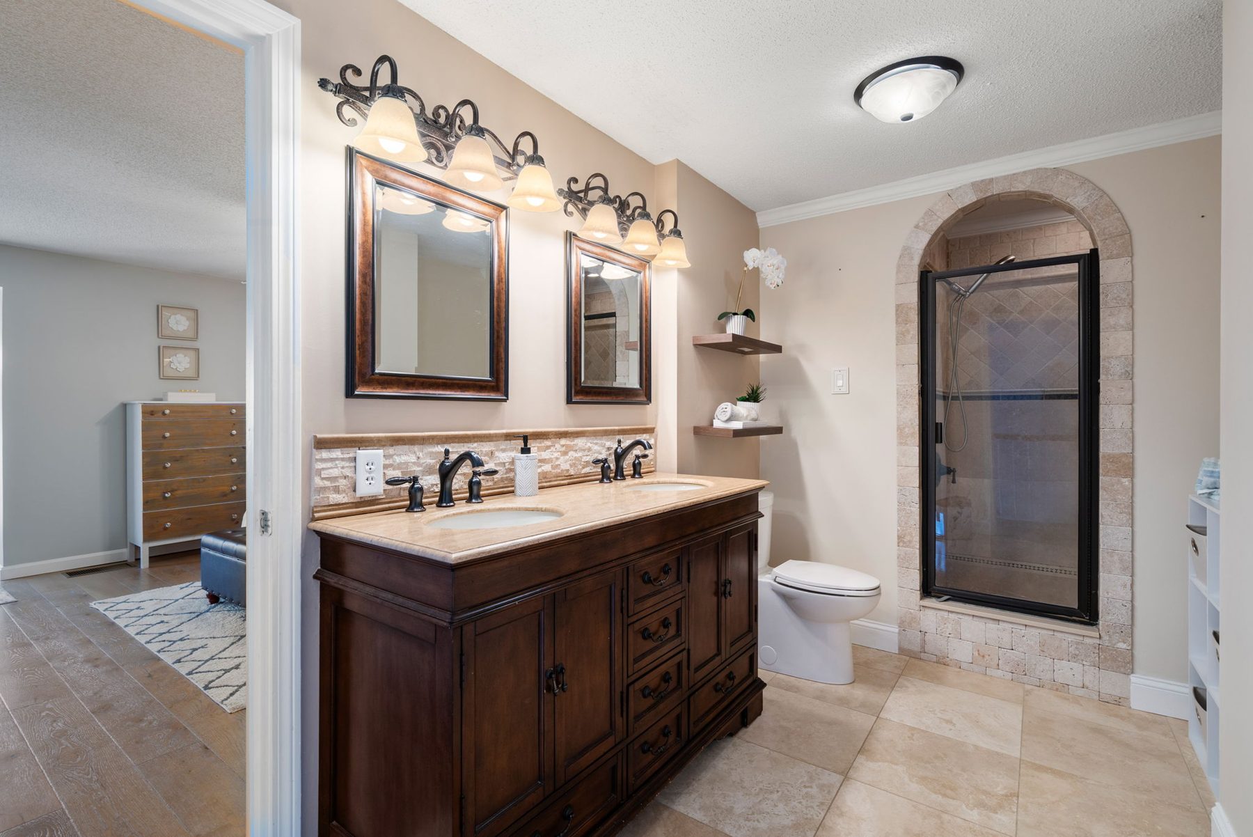 Meadowhill bath — travertine, arched shower, double vanity — after
