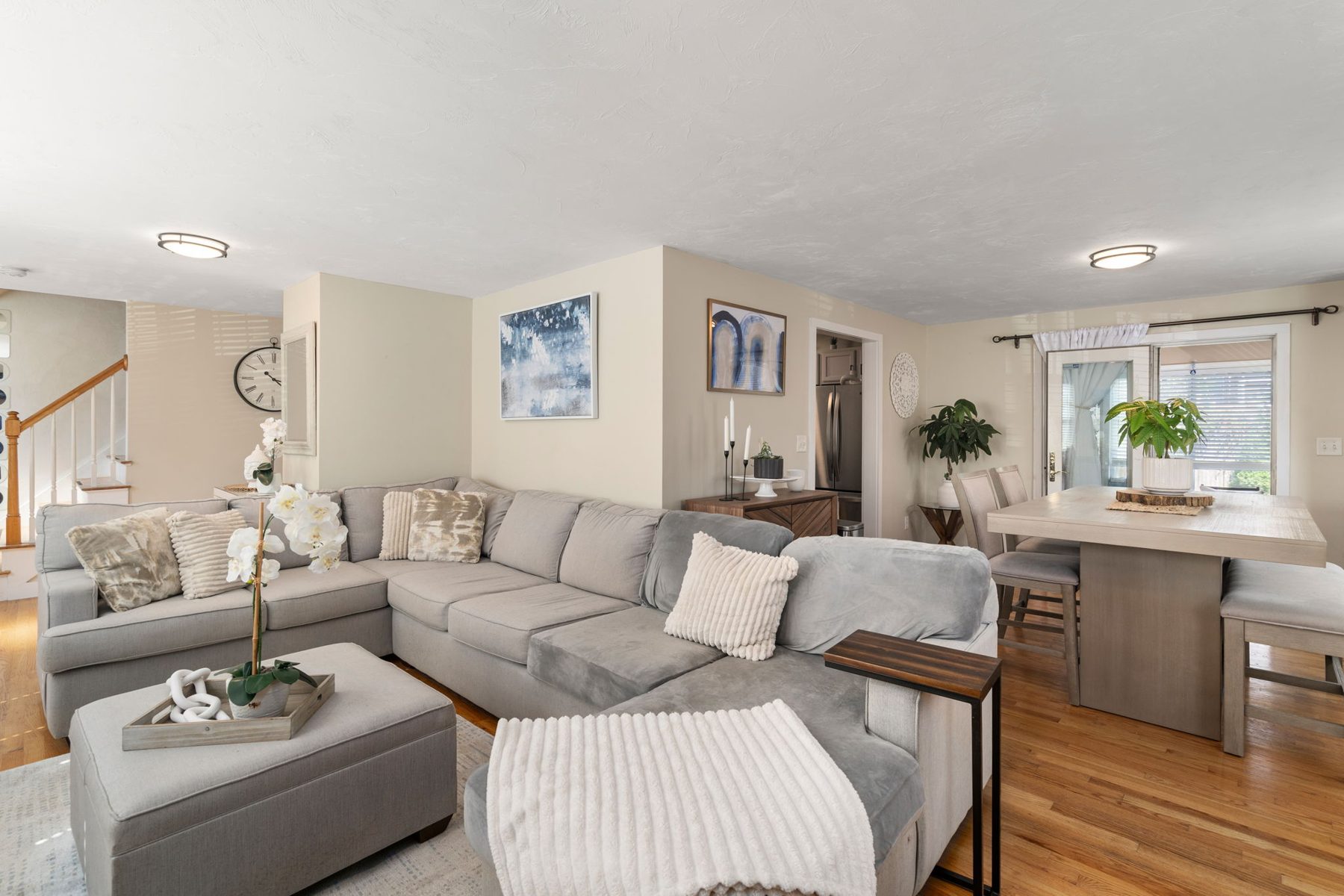 Norwell open plan — living into dining into kitchen, one sightline — after