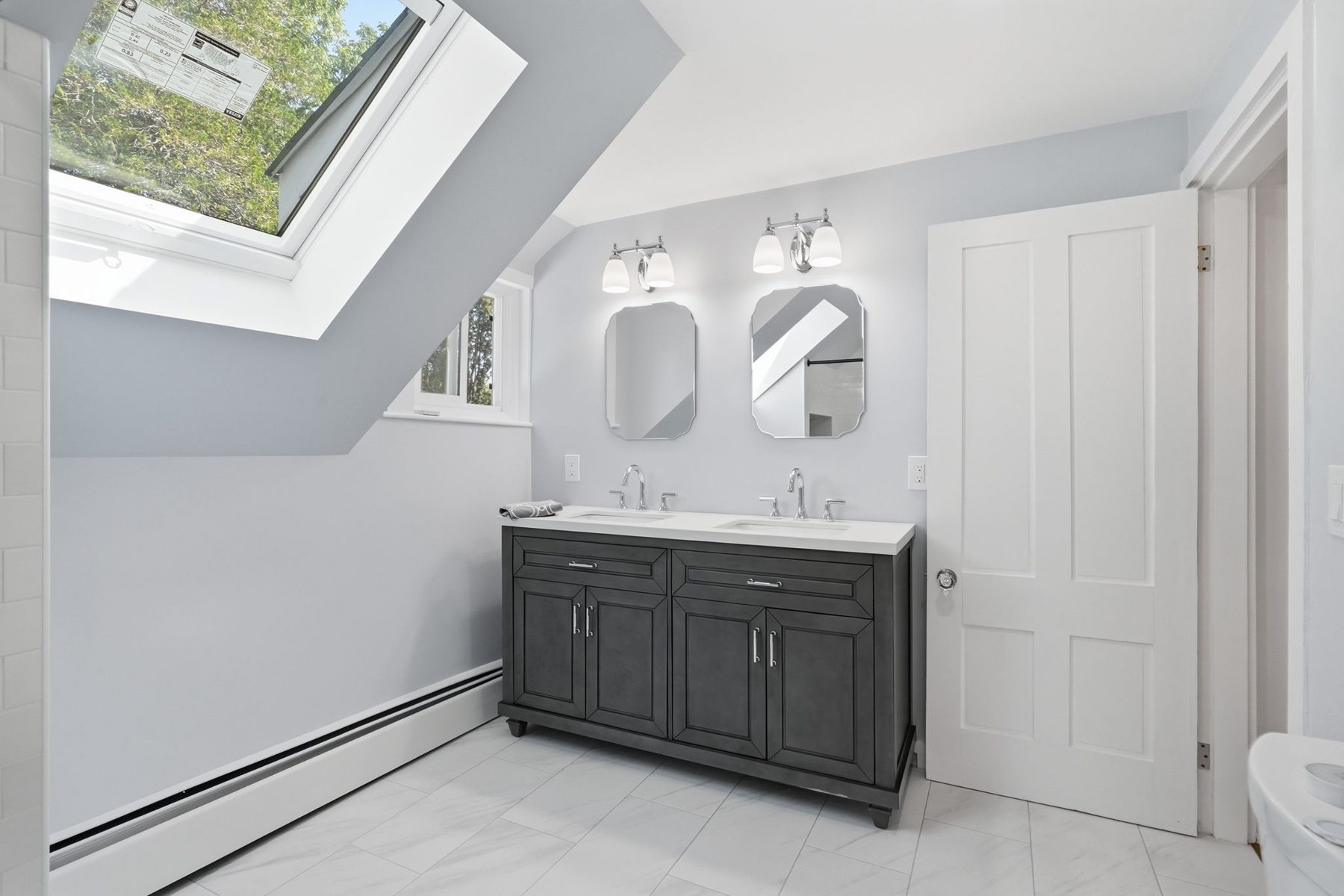 Pemberton bath skylight — gray double vanity under a skylight — after