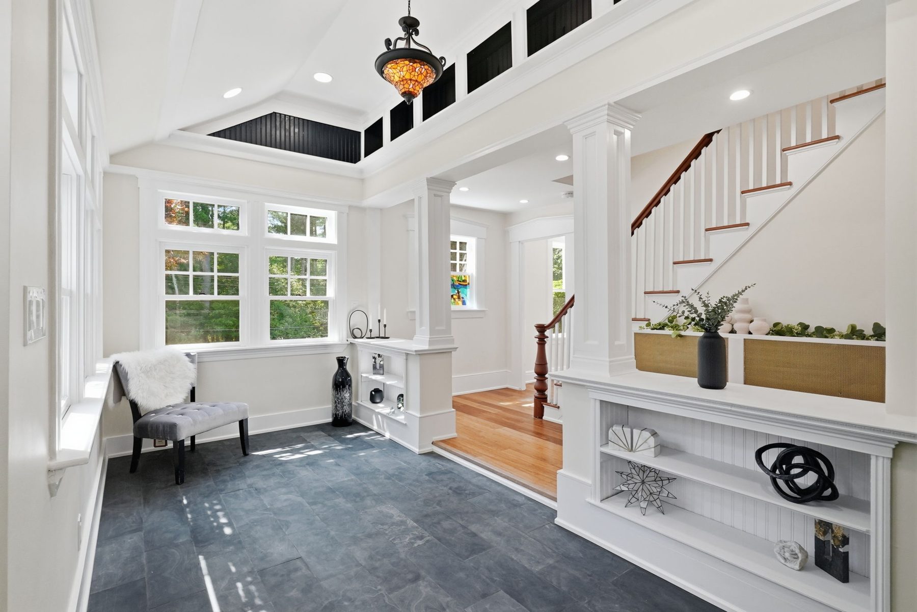 Pemberton entry — slate floor, stained-glass pendant, built-in bench — after