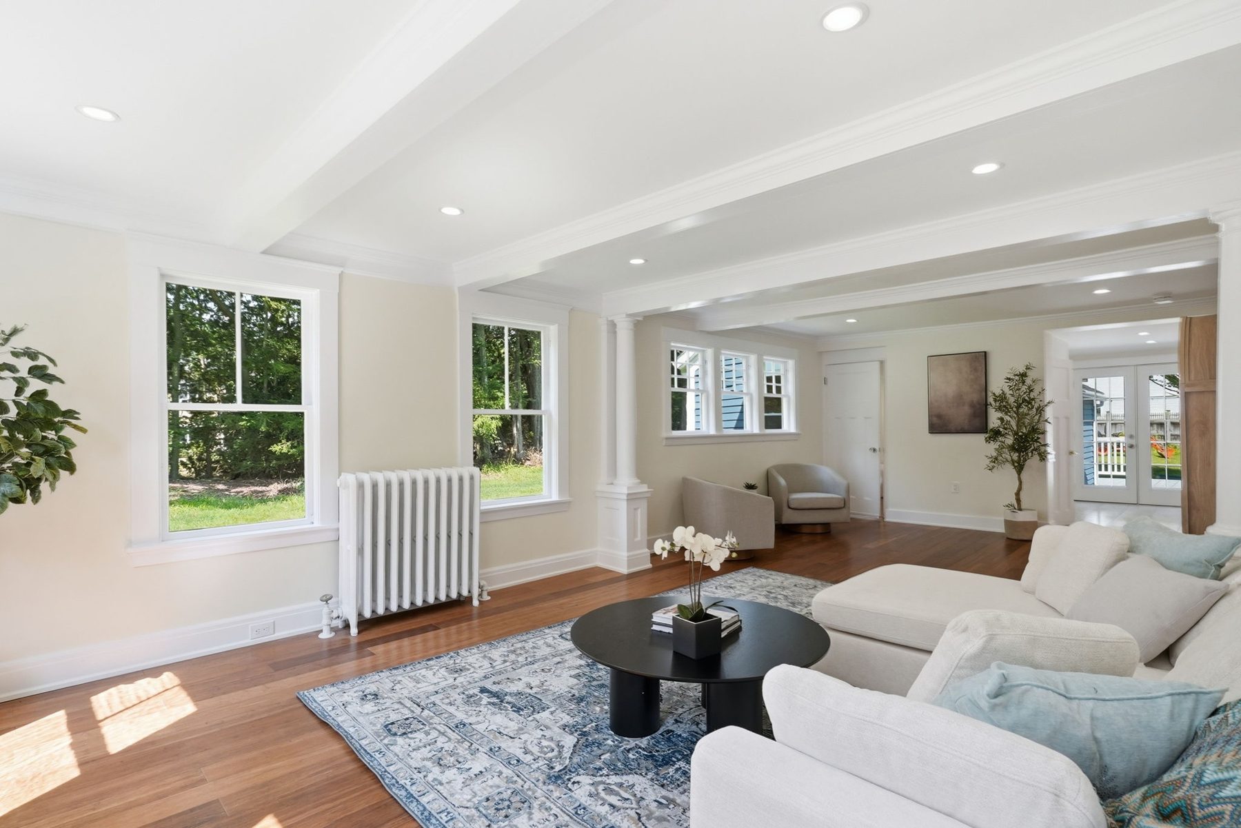 Pemberton family room — columns, beams, and the radiator we kept — after