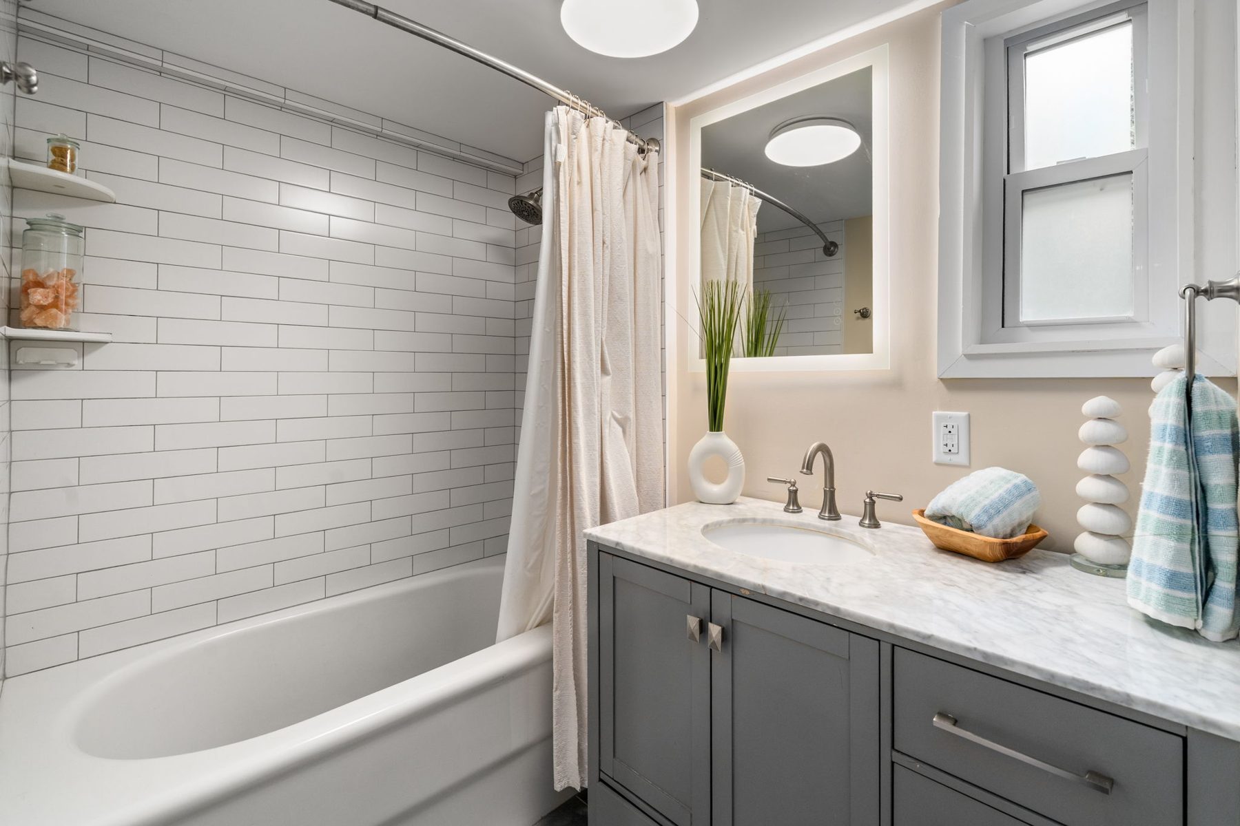 Summit bath — subway tile and marble, styled without the clutter — after