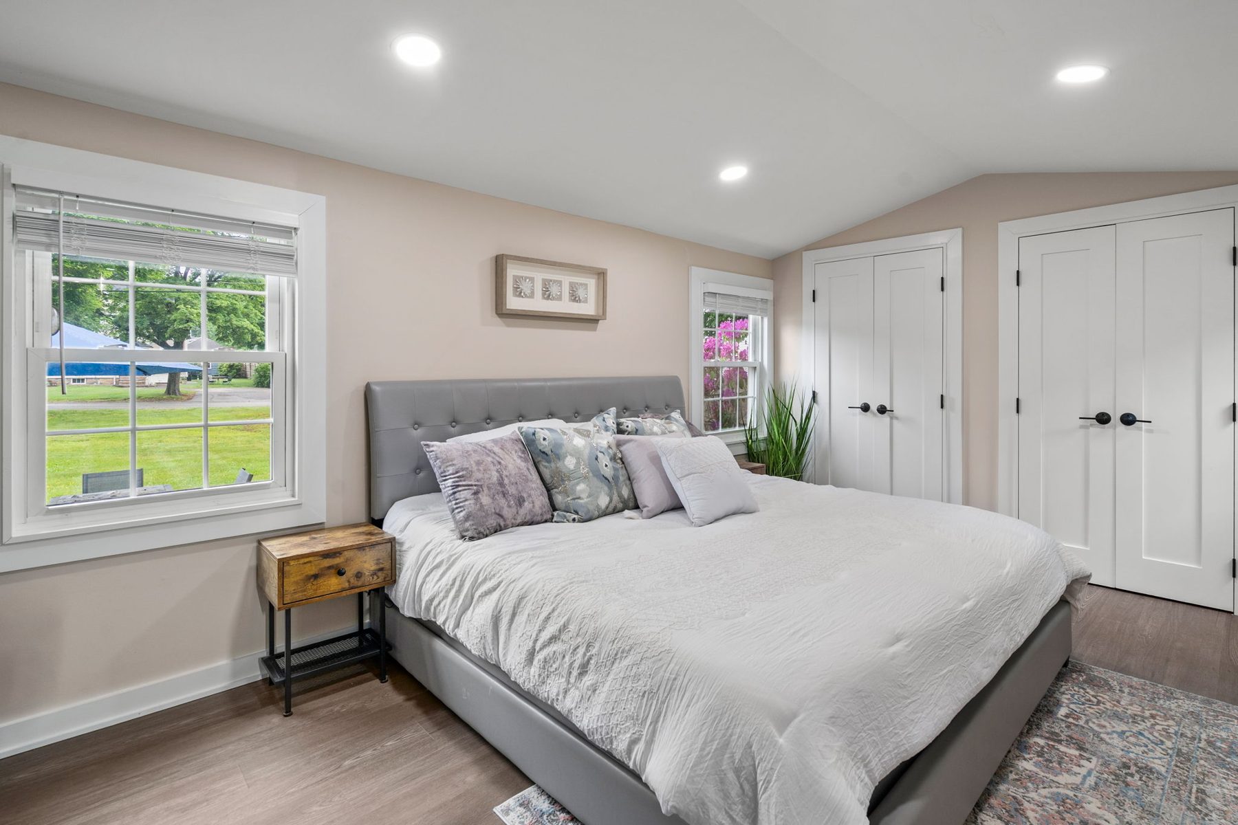 Summit bedroom — vaulted ceiling, double closets, king bed to prove the room fits one — after