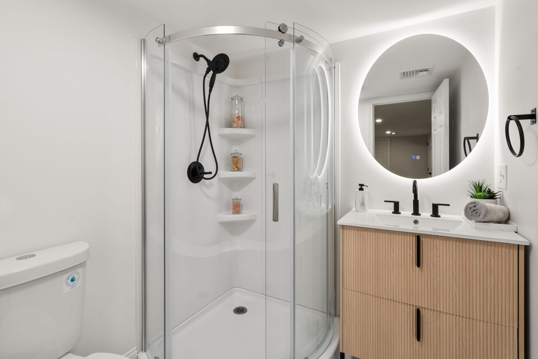 Wilshire bath 2 — lower level, glass shower, black fixtures — after