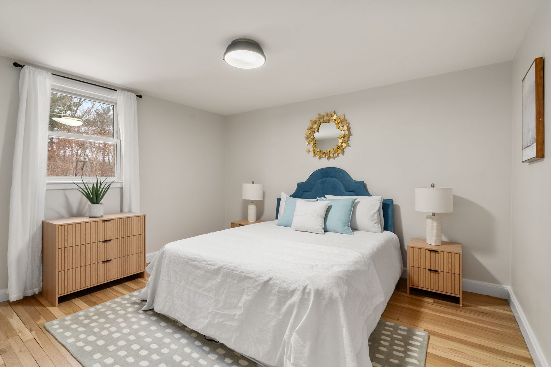 Wilshire bedroom 2 — blue velvet headboard, gold sunburst — after