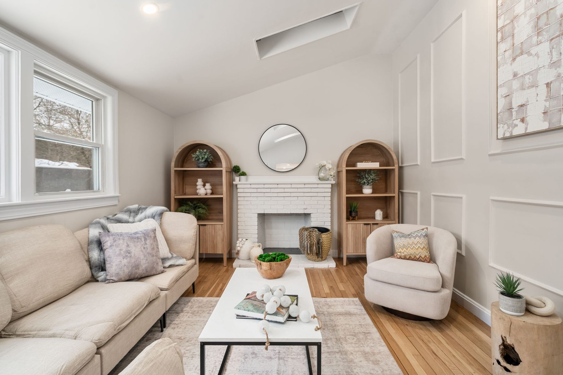 Wilshire living fireplace — painted brick, arched bookcases, board-and-batten — after